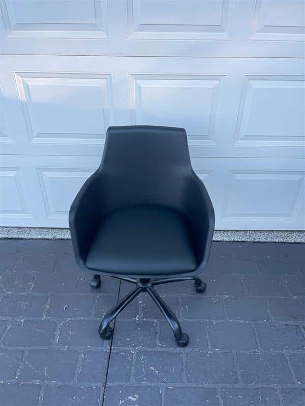 Black office chair on gray floor