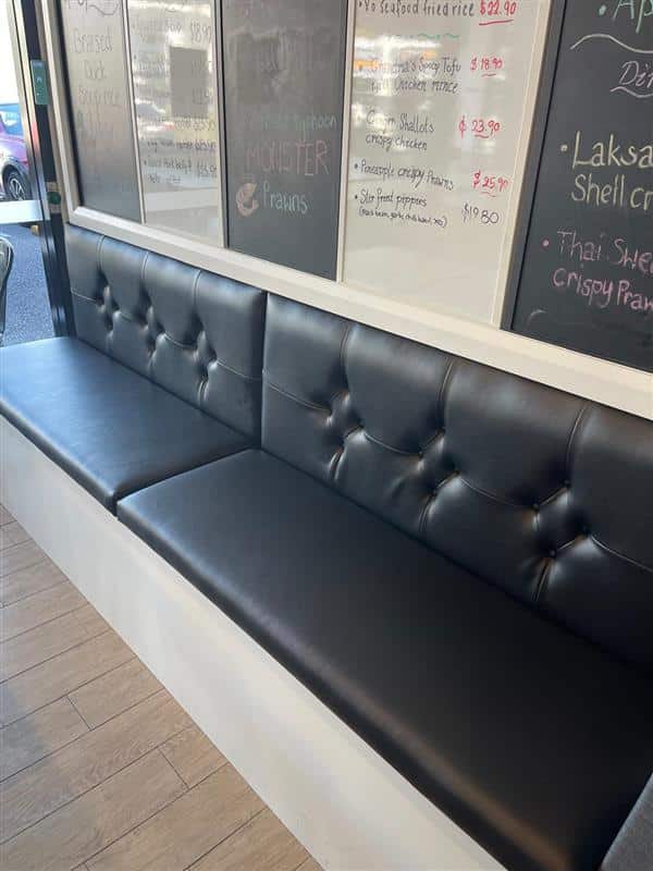 Black tufted seating in restaurant