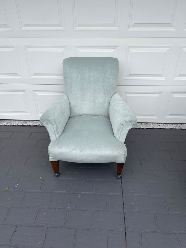 Light blue armchair on pavement
