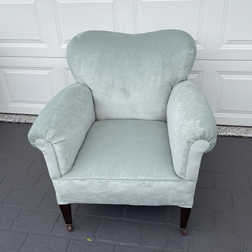 Light blue upholstered armchair on wheels