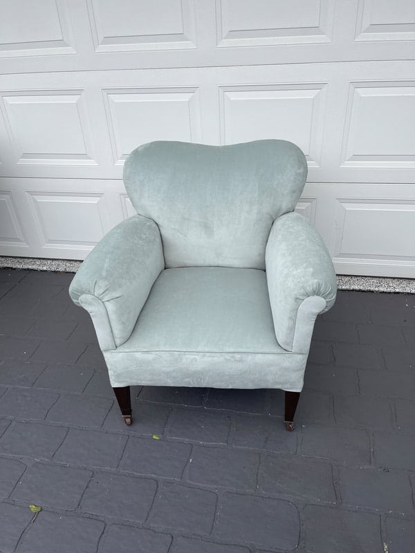 Light blue upholstered armchair with legs