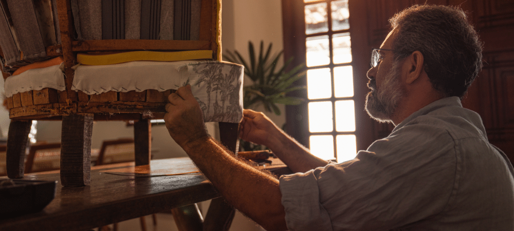 Man repairing a chair upholstery.