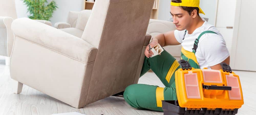 Man repairing furniture with tools.
