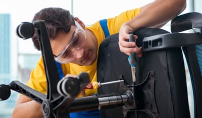 Man repairing office chair mechanism