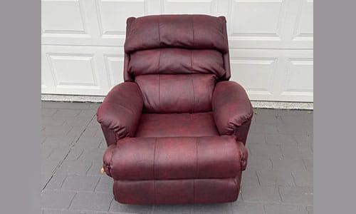 Maroon recliner chair with cushions
