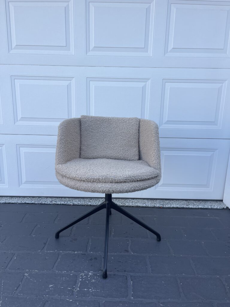 Modern beige swivel chair on wheels