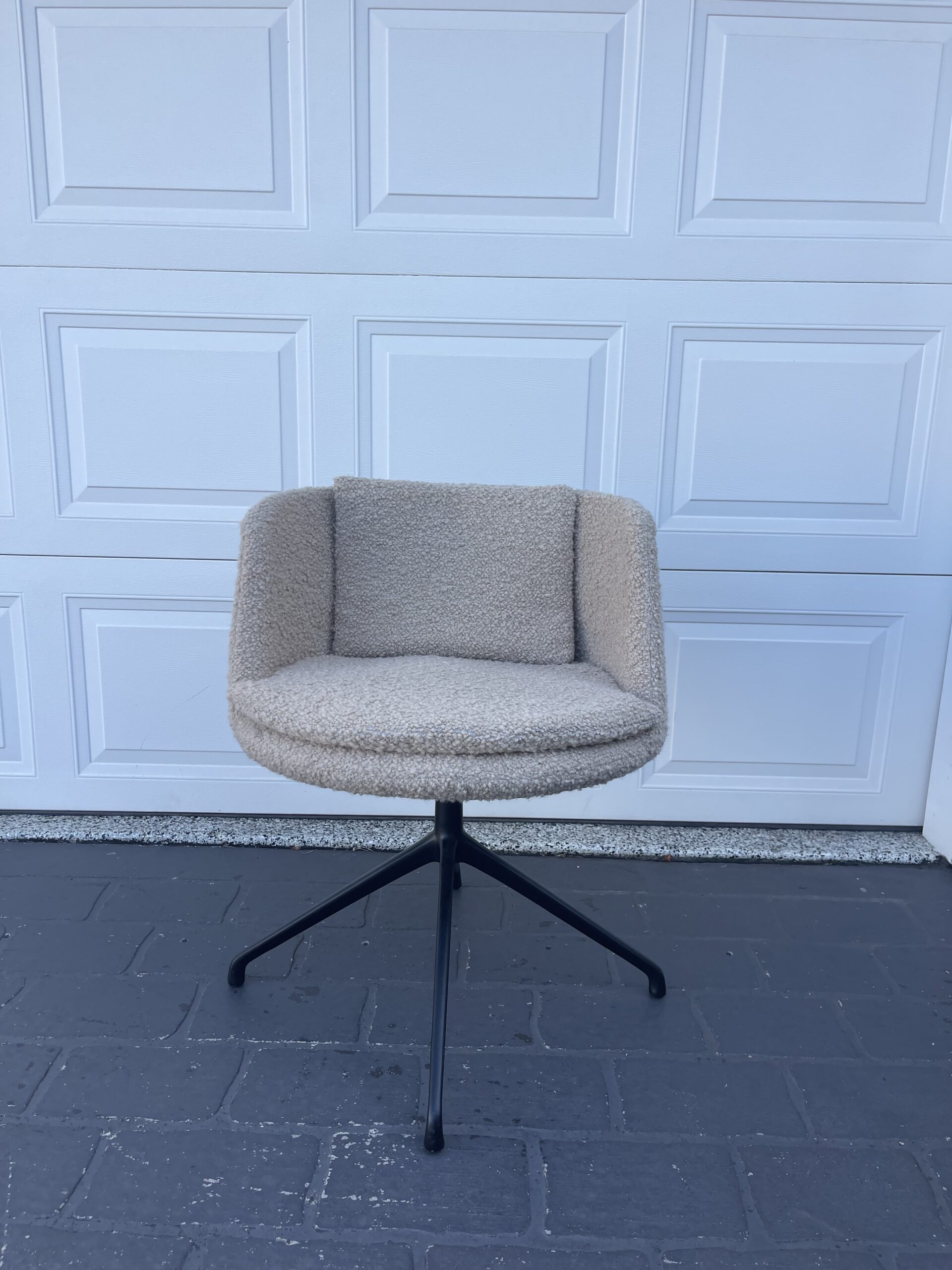 Modern beige swivel chair on wheels