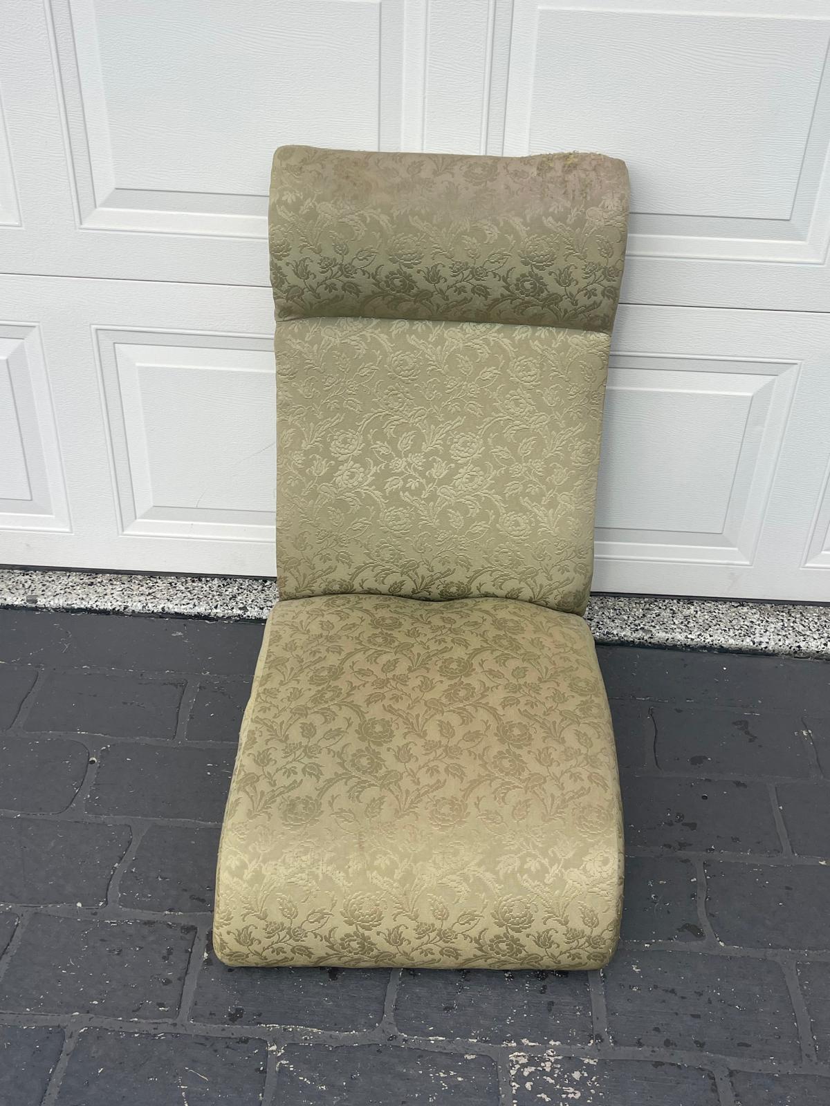 Old patterned chair against garage door