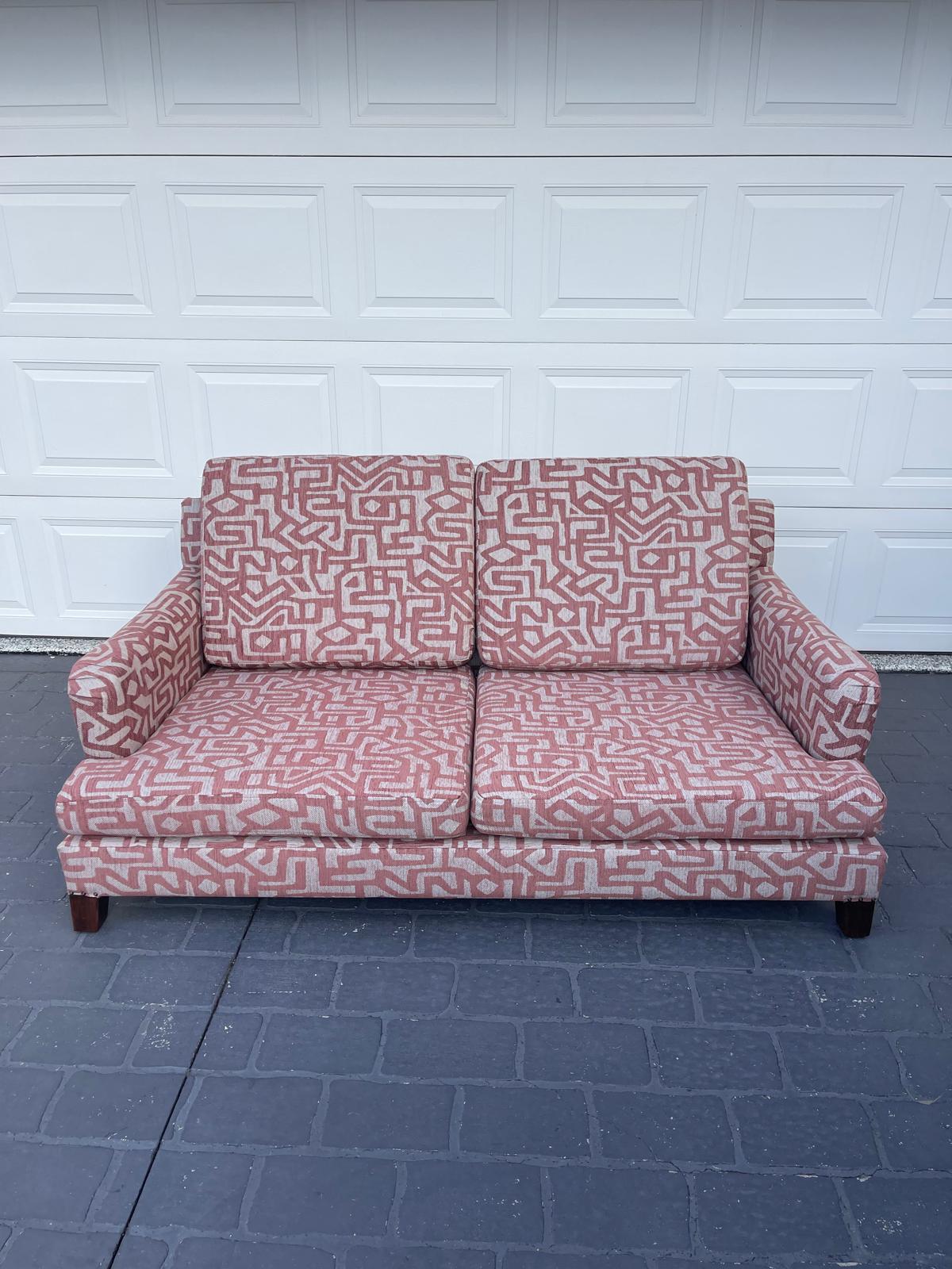 Patterned two-seat couch on pavement