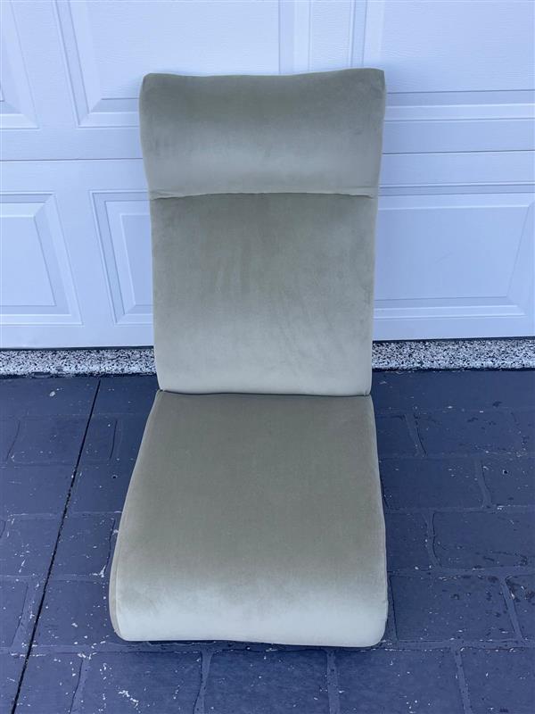 Simple green lounge chair on floor