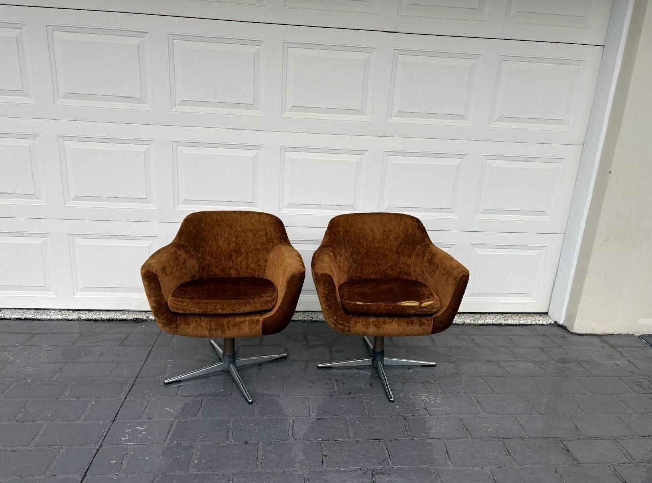 Two brown swivel chairs on pavement