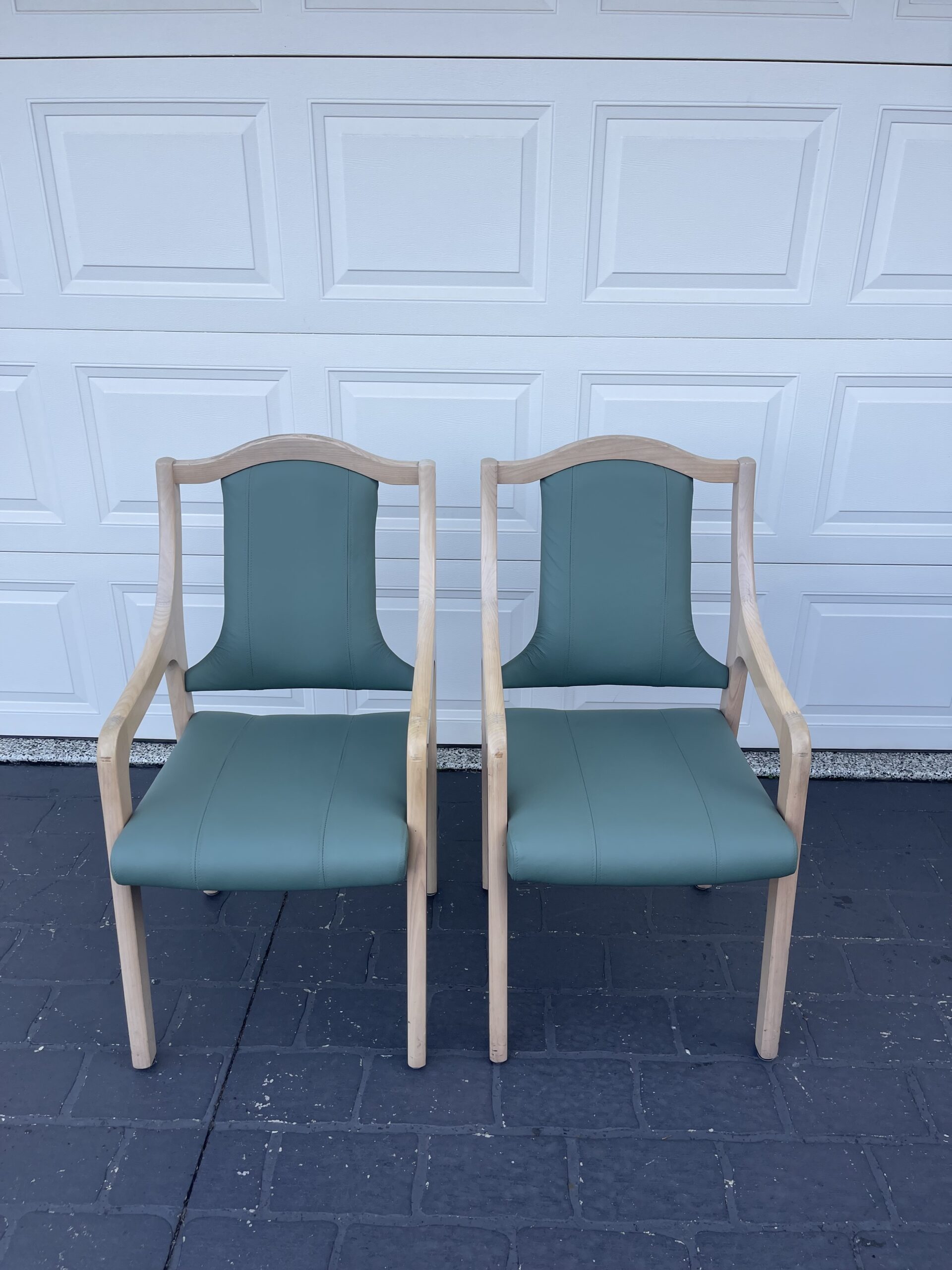 Two green chairs with wooden frames