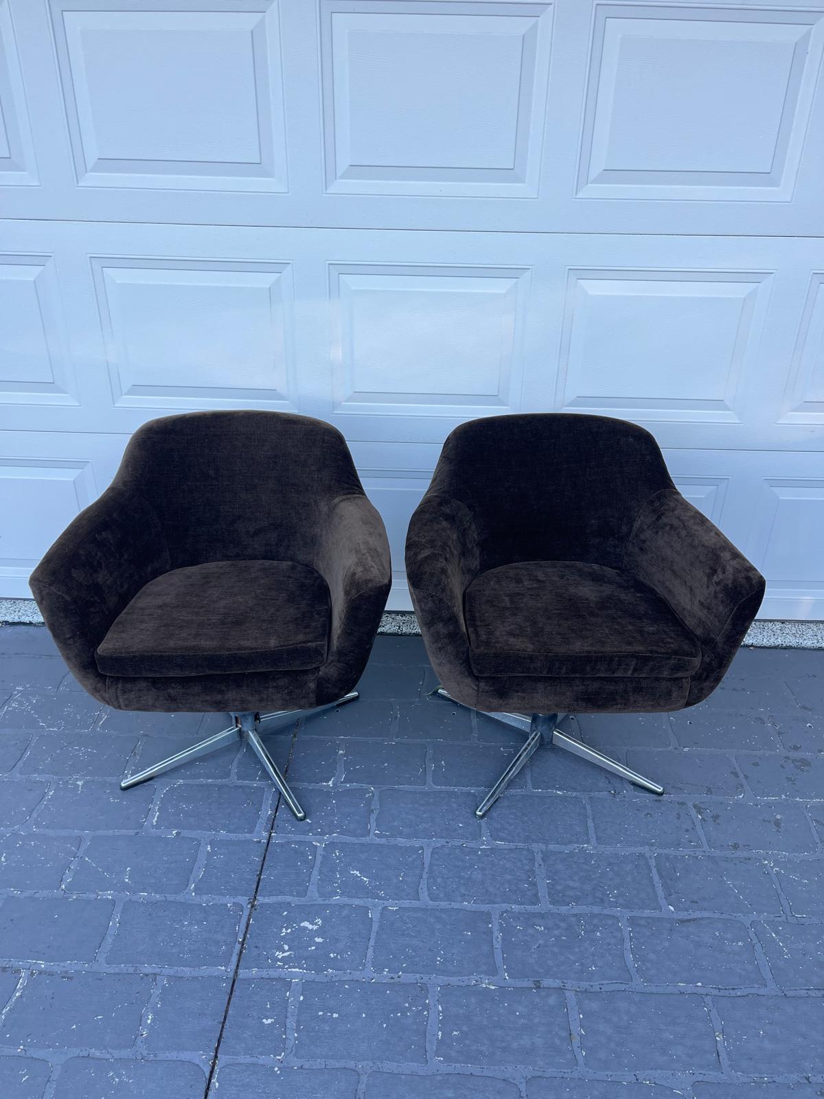 Two modern brown swivel chairs