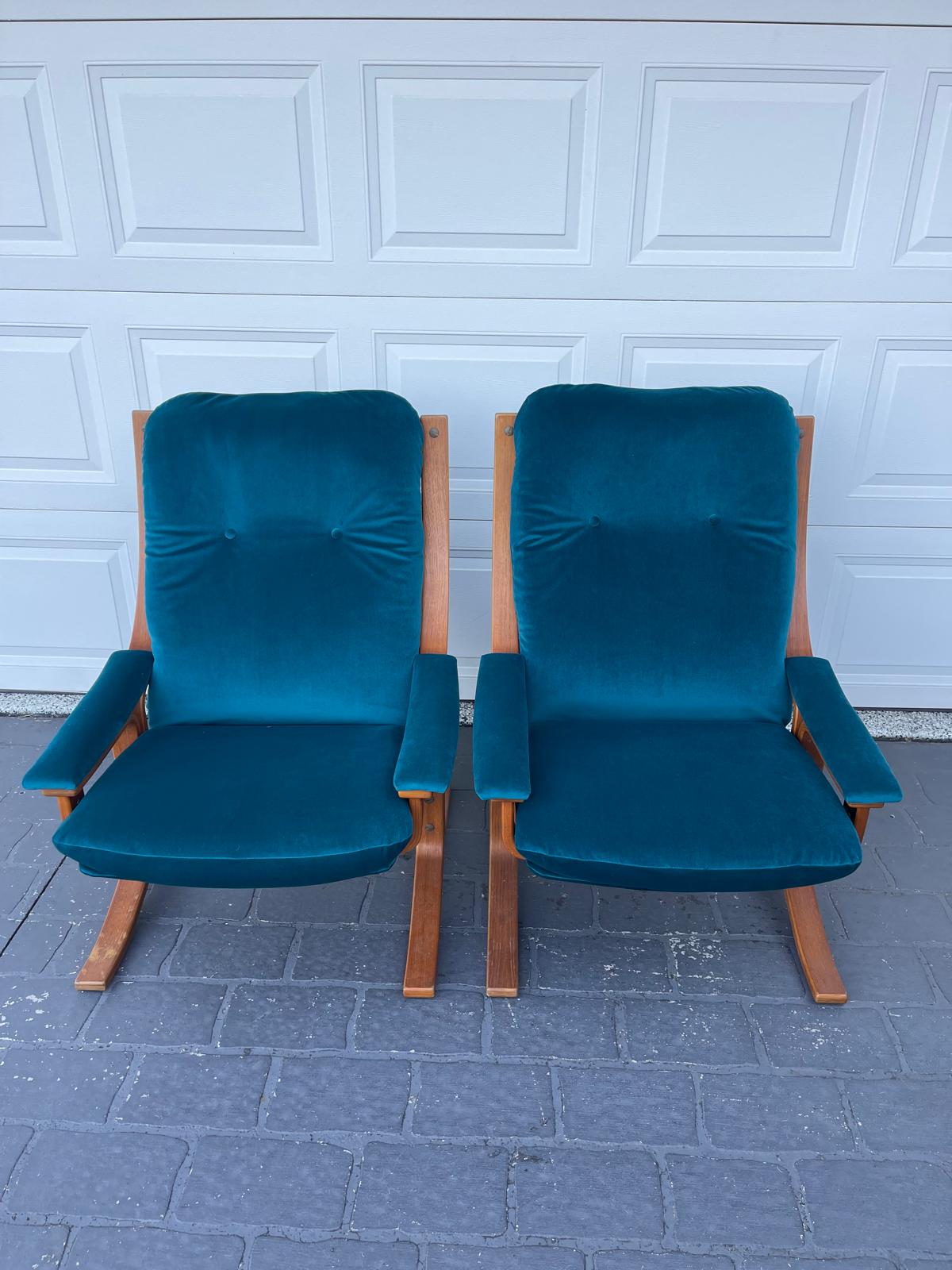 Two teal velvet lounge chairs