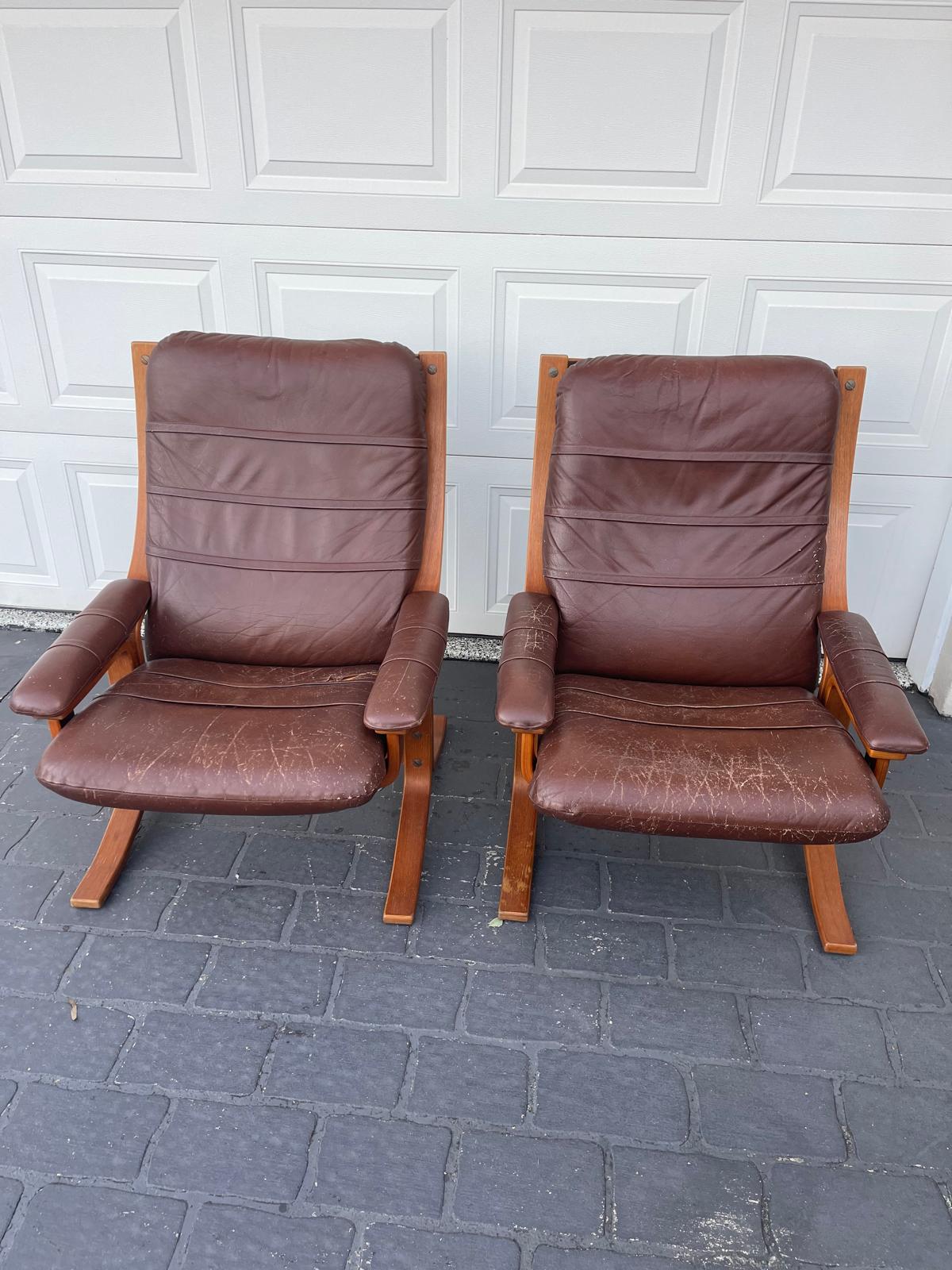 Two vintage brown leather chairs