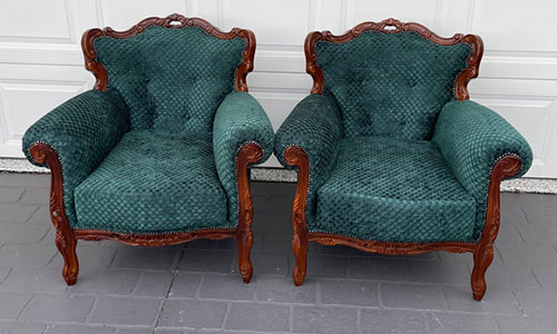 Two vintage green upholstered armchairs