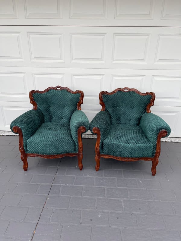 Two vintage green upholstered armchairs