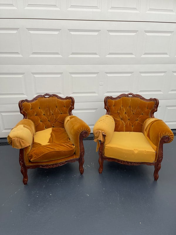 Two vintage yellow armchairs, worn