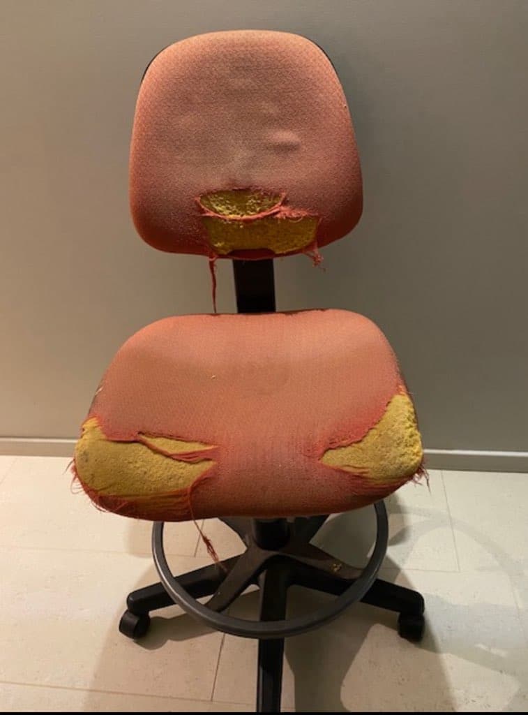 Worn-out office chair with damage