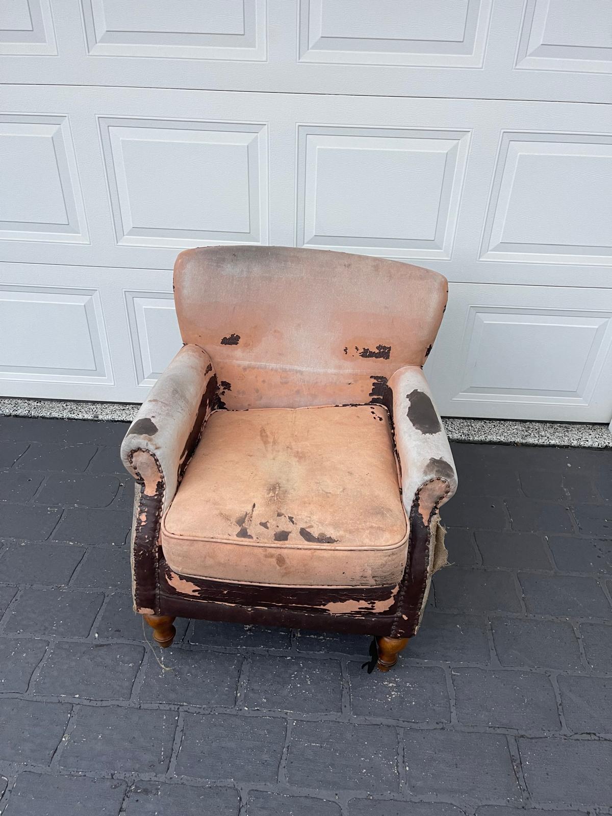 Worn-out vintage armchair with damage